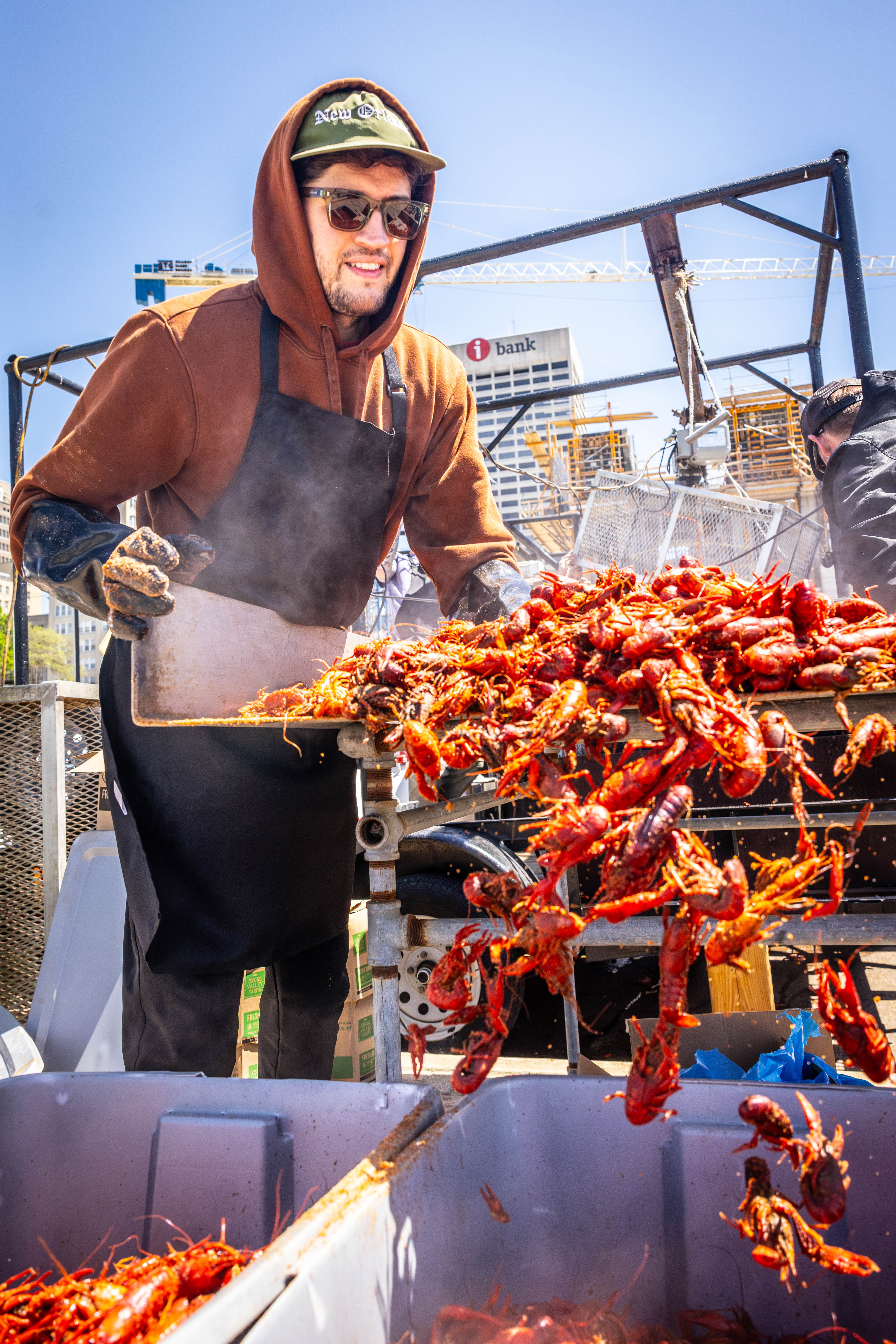 man pouring crawfish into bucket
